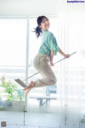 A woman in a blue pajamas posing for a picture.