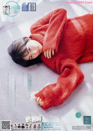 A woman sitting at a table with a stuffed animal.