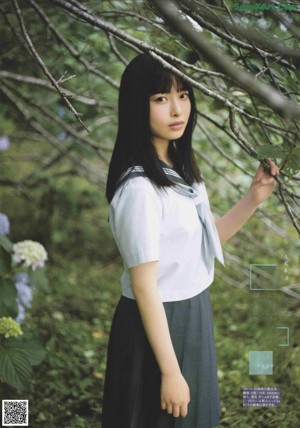 A magazine page with a picture of a woman in a blue dress.