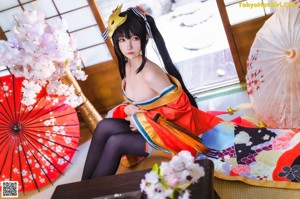 A woman in a kimono with a mask on her head.