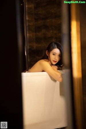 a woman in a bathtub with a wet body