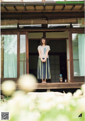 A woman in a white shirt is posing for a picture.