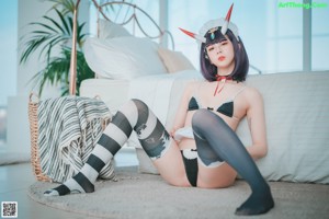 A woman in a maid outfit is posing for a picture.
