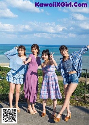 A couple of women standing next to each other on a beach.