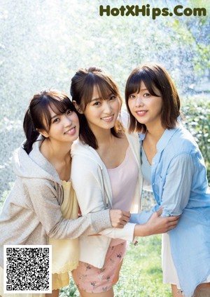 A group of three young women posing for a picture.