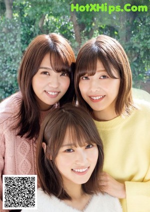 A group of three young women standing next to each other.