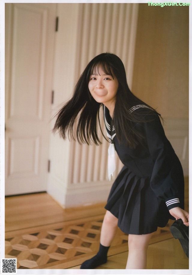 A woman in a school uniform posing for a picture.