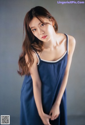A woman in a pink sweater and white shorts on a magazine cover.