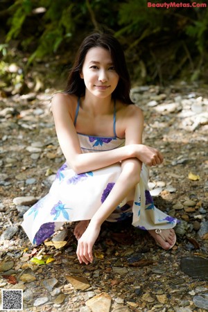 A woman in a pink lingerie laying on a blue surface.