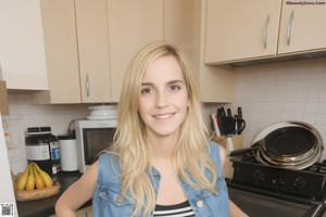 A woman in a red top and jeans posing for a picture.