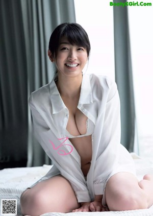 A woman in a blue dress posing for a picture.