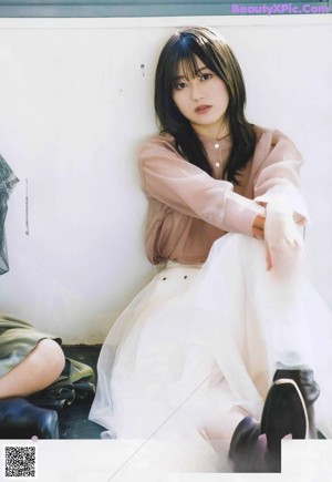 A magazine page with a picture of a woman in a white dress.